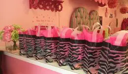 Zebra-stripped bags with pink fluff on a counter